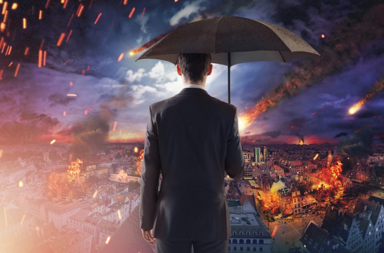 Image of man looking out across burning city