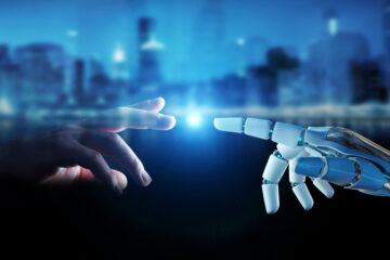 Image of human and robot hands touching.